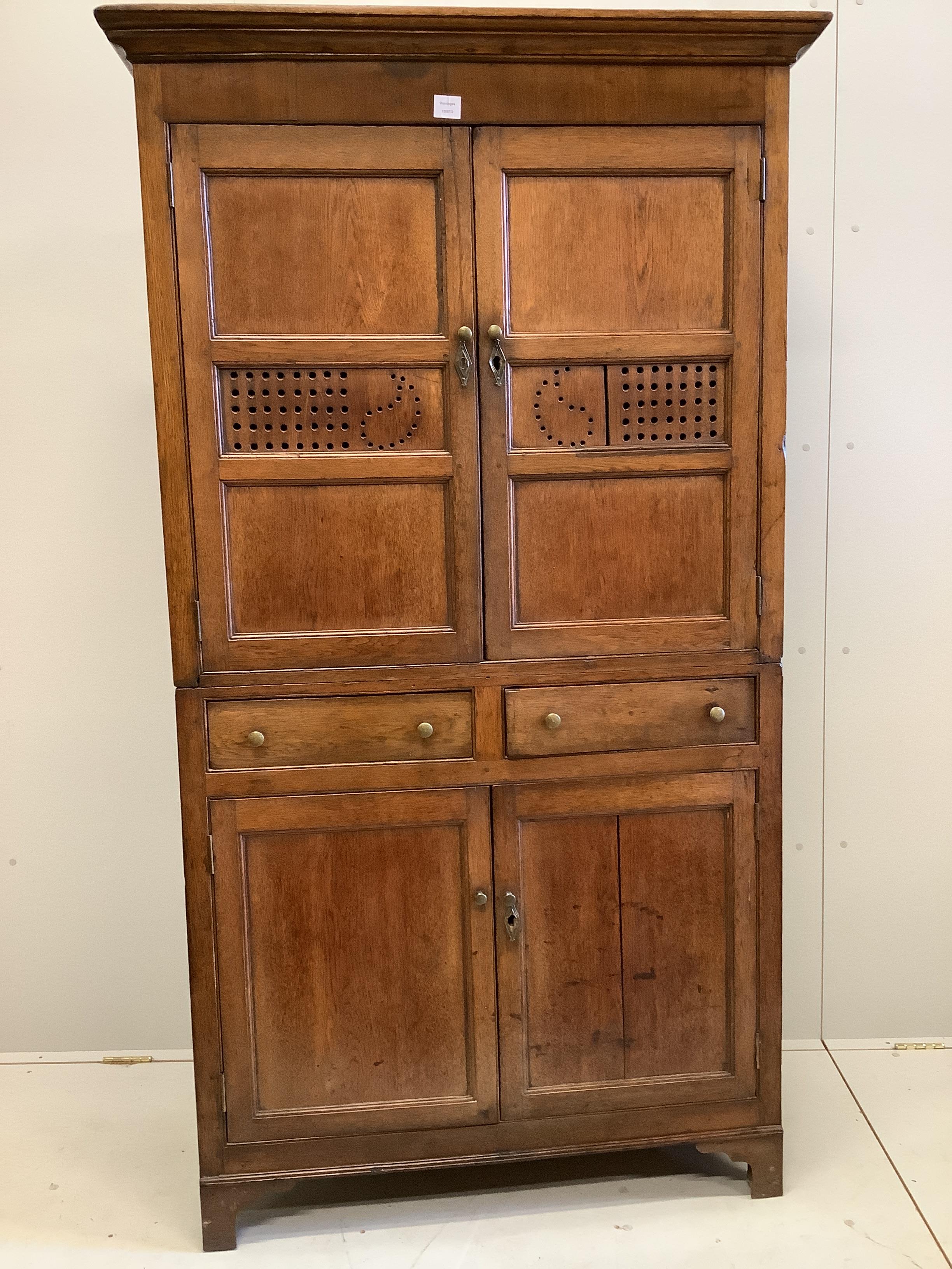 A George III Provincial oak household cabinet, width 108cm, depth 50cm, height 196cm